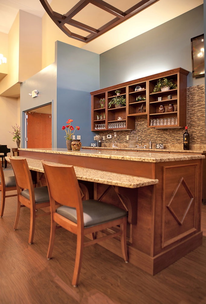 kitchen island and bar with tables and chairs