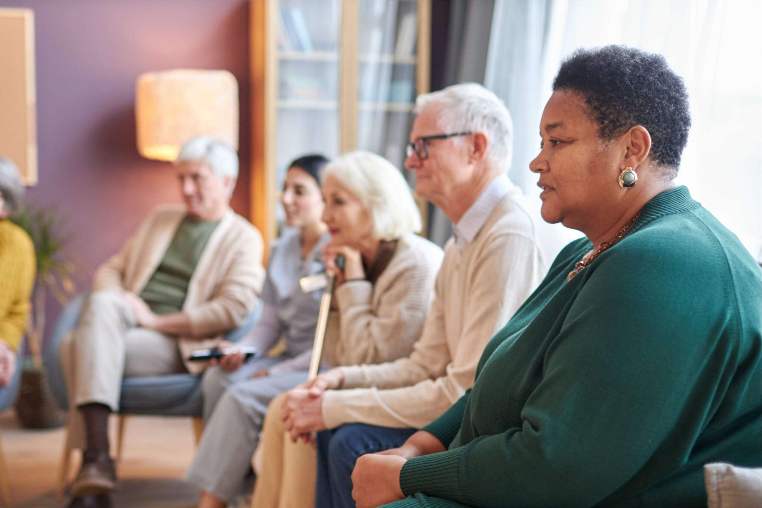 A group of seniors sitting on a couch together.